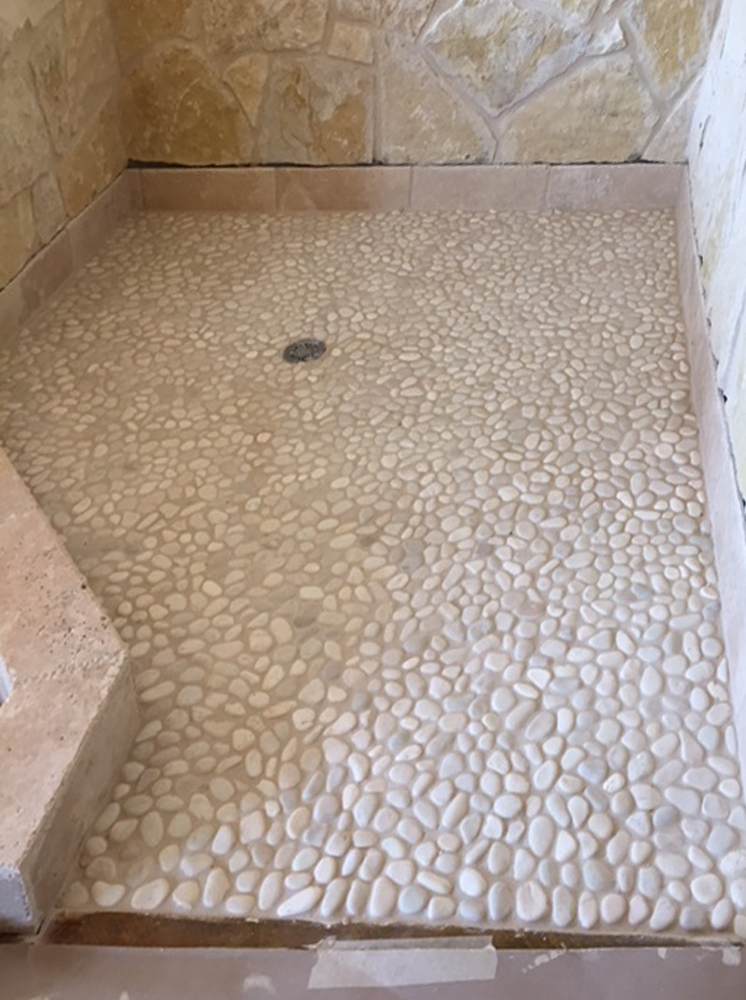 white pebble tile shower pan with stone walls - Pebble Tile Shop